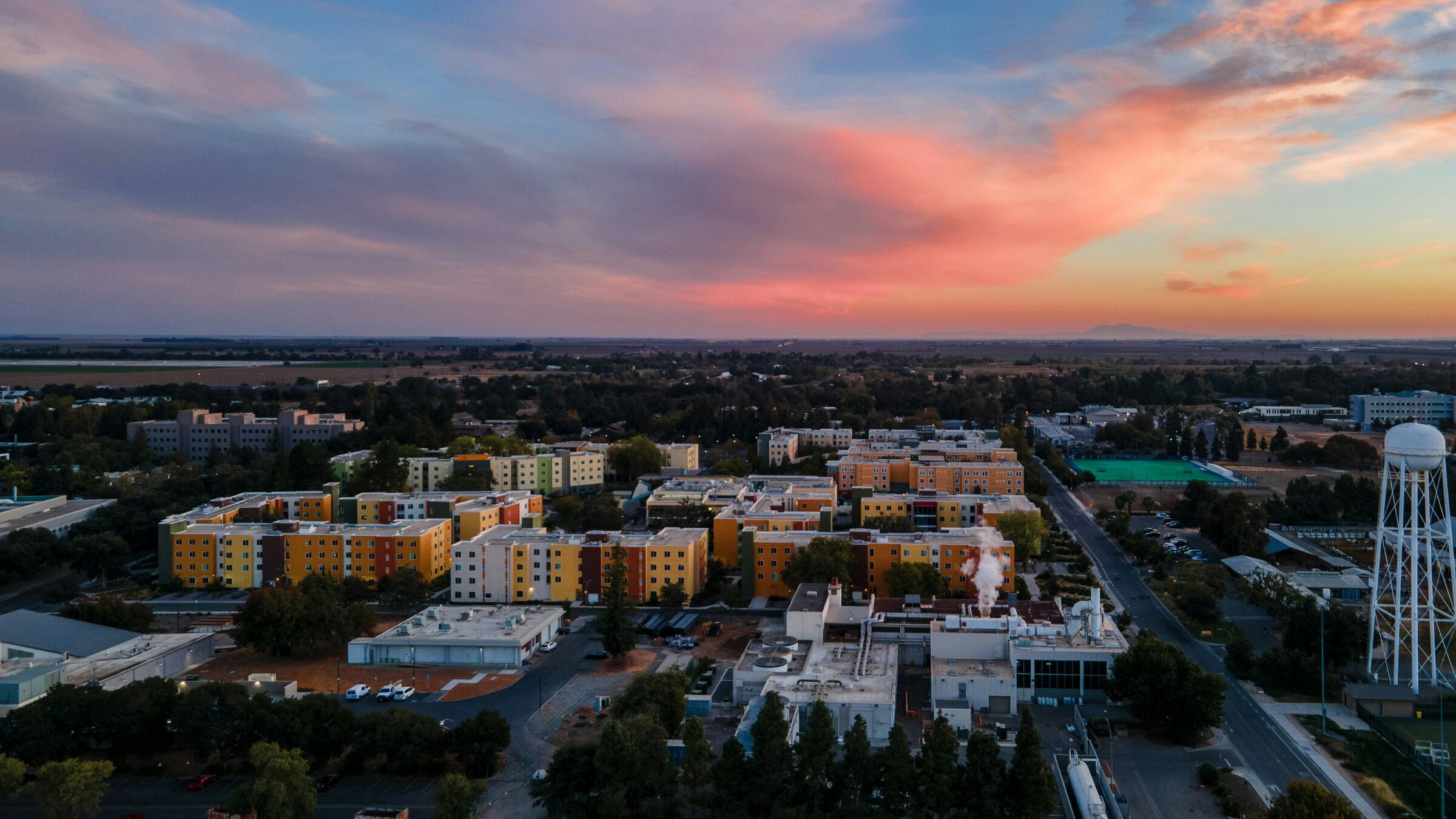 Aerial view of UC Davis and the surrounding city at sunset